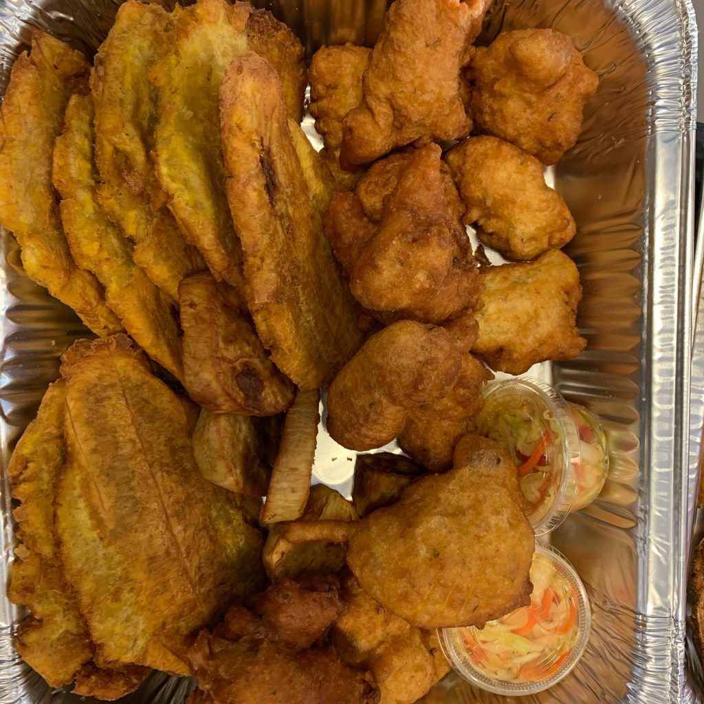 A tray filled with various fried Haitian foods