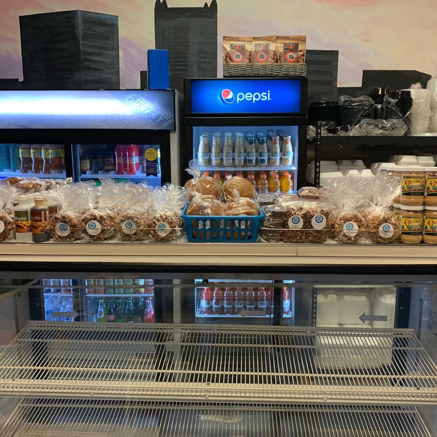 A display case showcasing an assortment of food items and beverages, inviting customers to explore the offerings.